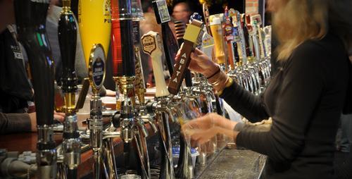 Woman Barista Serving Beer