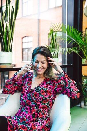 High-End Single Woman Smiling While Tallking To Someone Over The Phone
